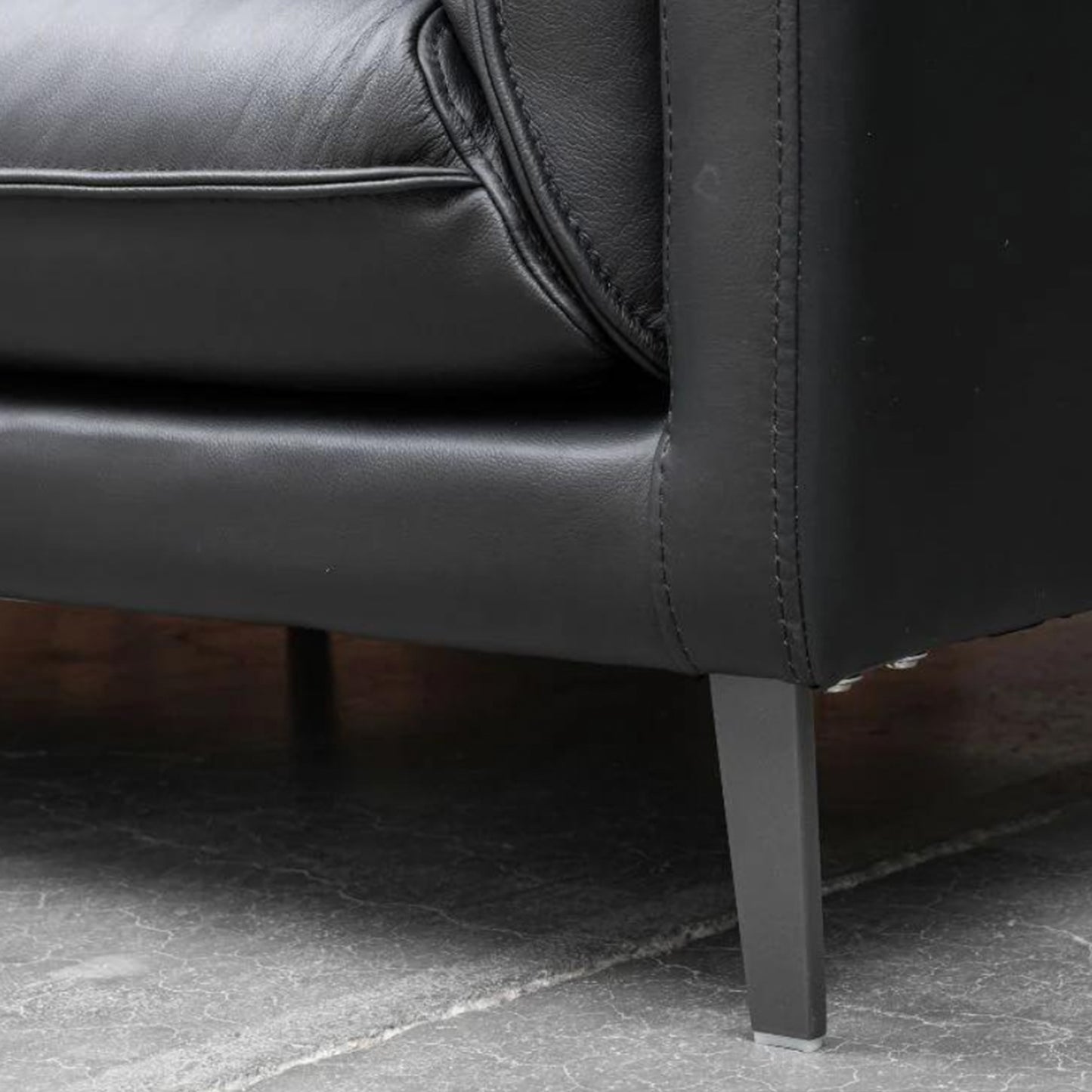 Detail shot of Klaussner Dolce chair metal legs and base showing stable support structure for Comfort Design Furniture
