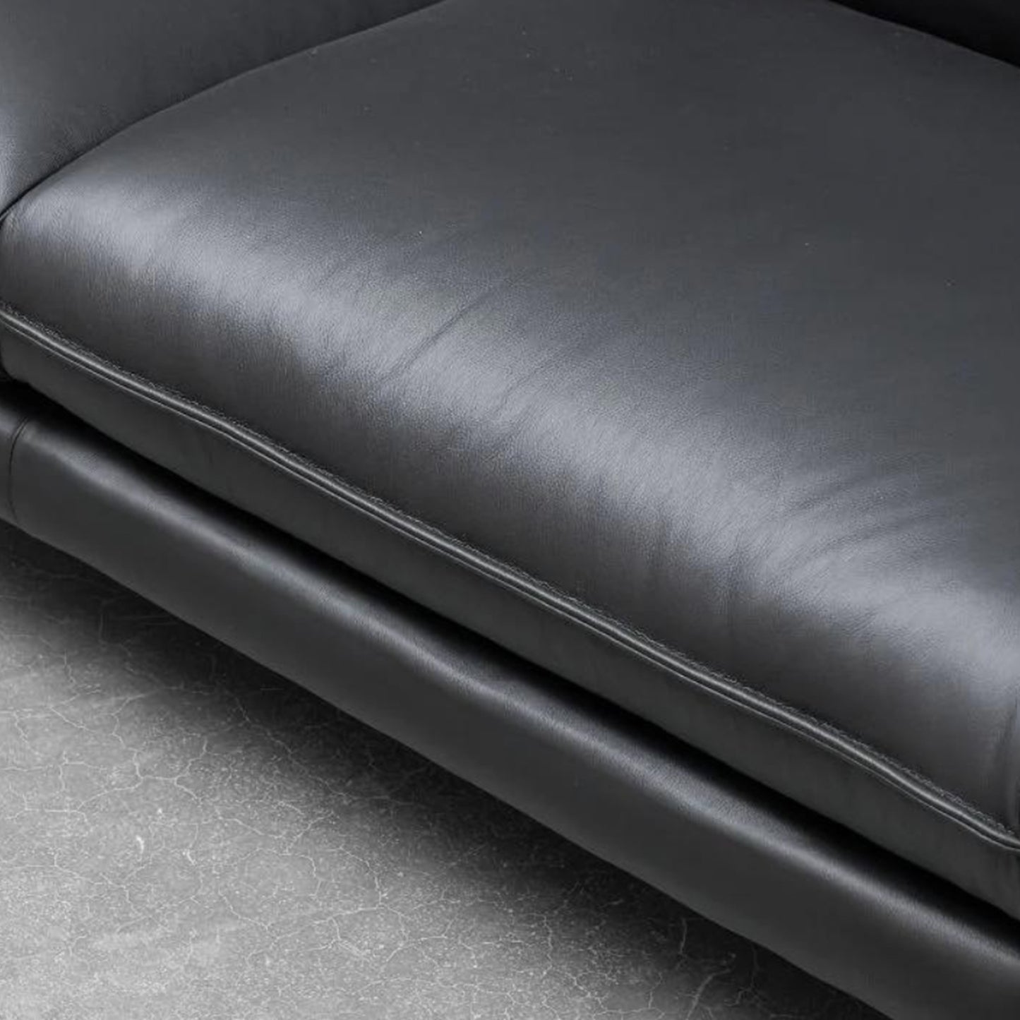 Close-up of Klaussner Dolce sofa's refined deep stitching and premium black leather texture for Comfort Design Furniture