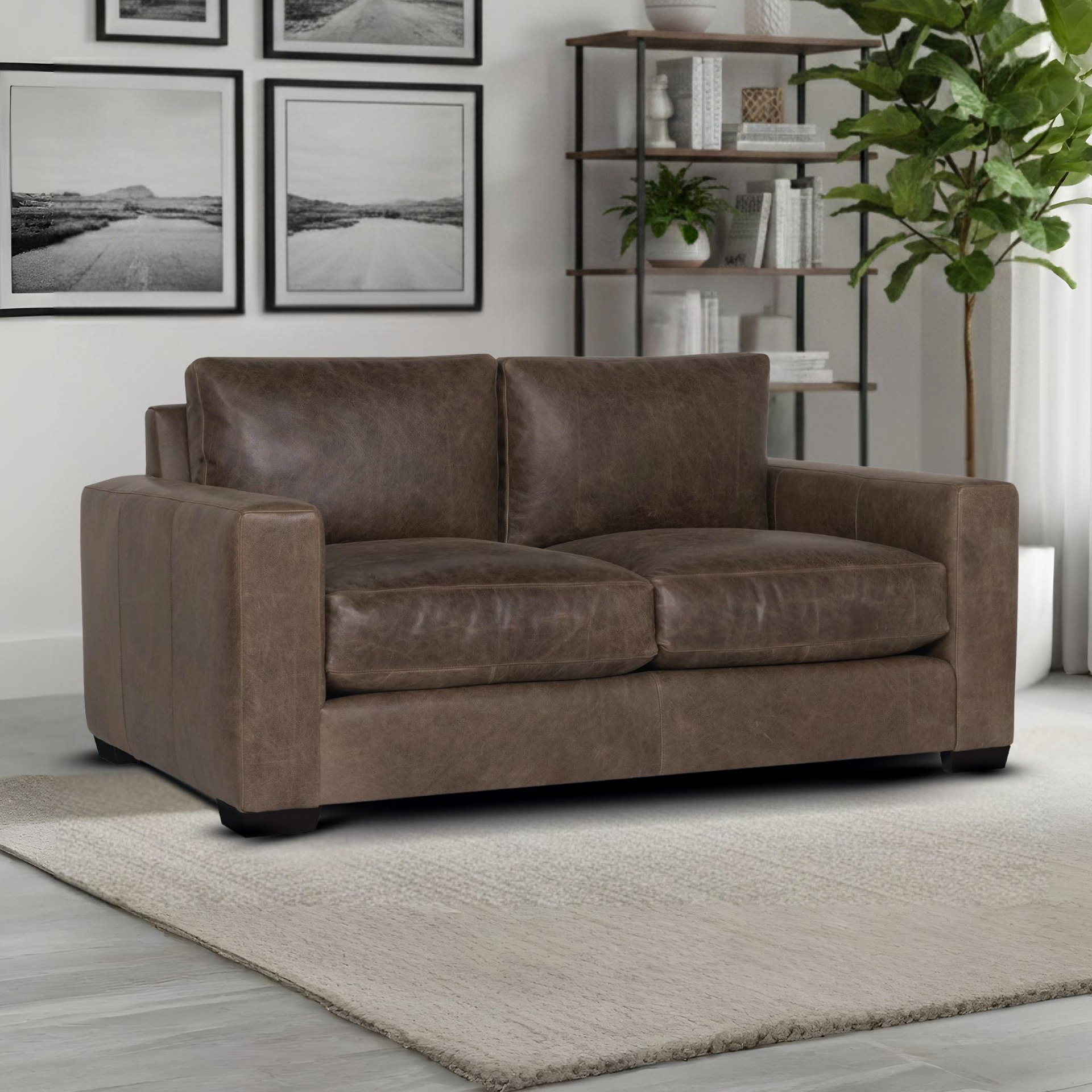 Leather loveseat in room setting showing scale and placement for comfort design furniture